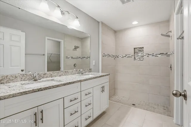 a bathroom with a granite countertop sink mirror and double