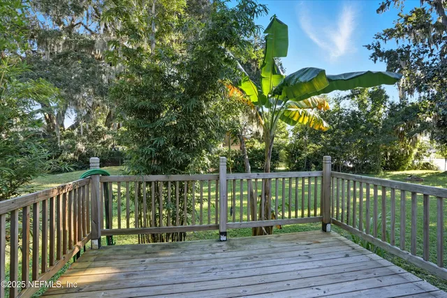 a view of a wooden deck with a yard