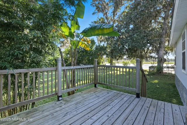 a view of a deck with wooden floor and fence