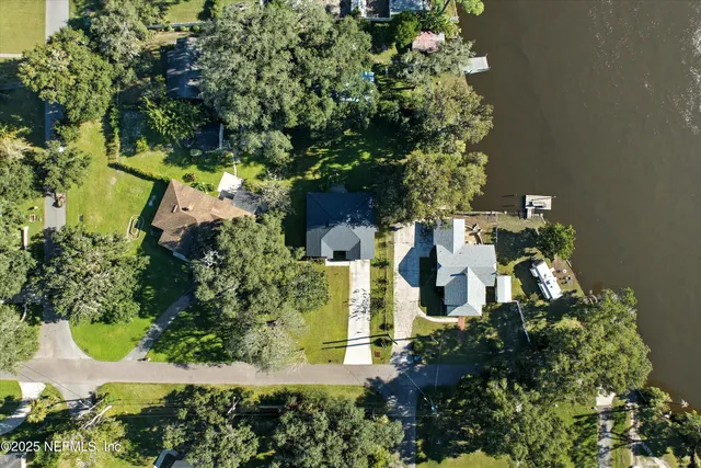 an aerial view of a house with yard swimming pool and outdoor seating