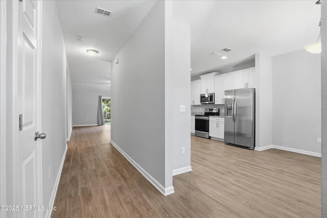 a view of kitchen view wooden floor and electronic appliances