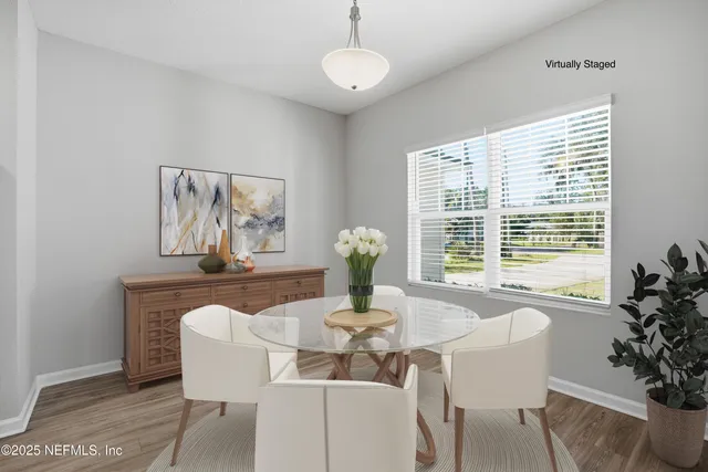 a dining room with furniture and window