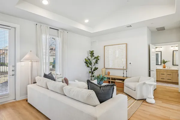a living room with furniture and a potted plant