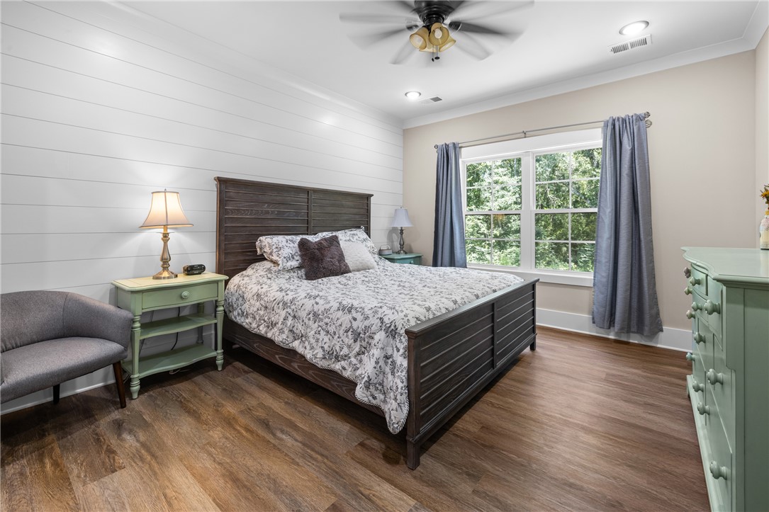 322 Thompson Street Pendleton, SC 29670 - Photo 24 of 38 Gleaming floors and a shiplap feature wall define this inviting bedroom retreat.