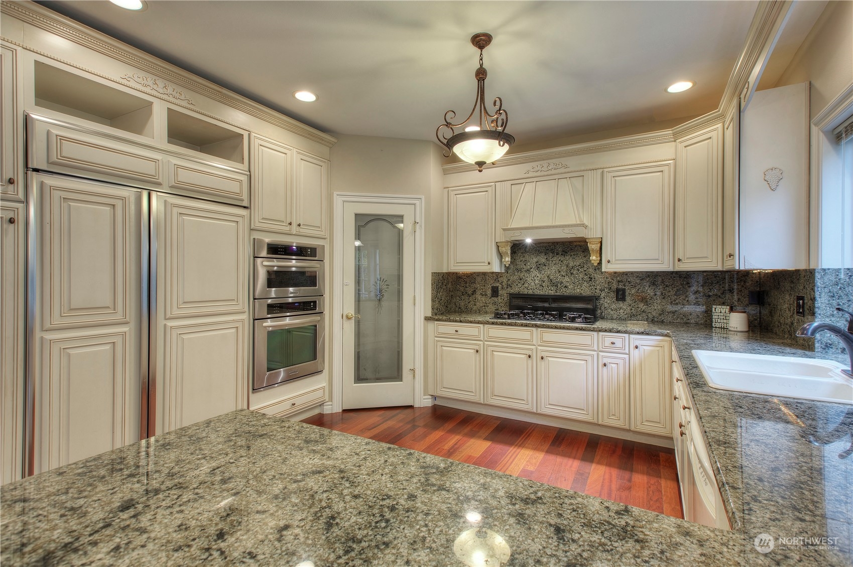 1013 R Street Northwest Auburn, WA 98001 - Photo 9 of 31 a kitchen with stainless steel appliances granite countertop a refrigerator a stove and a sink