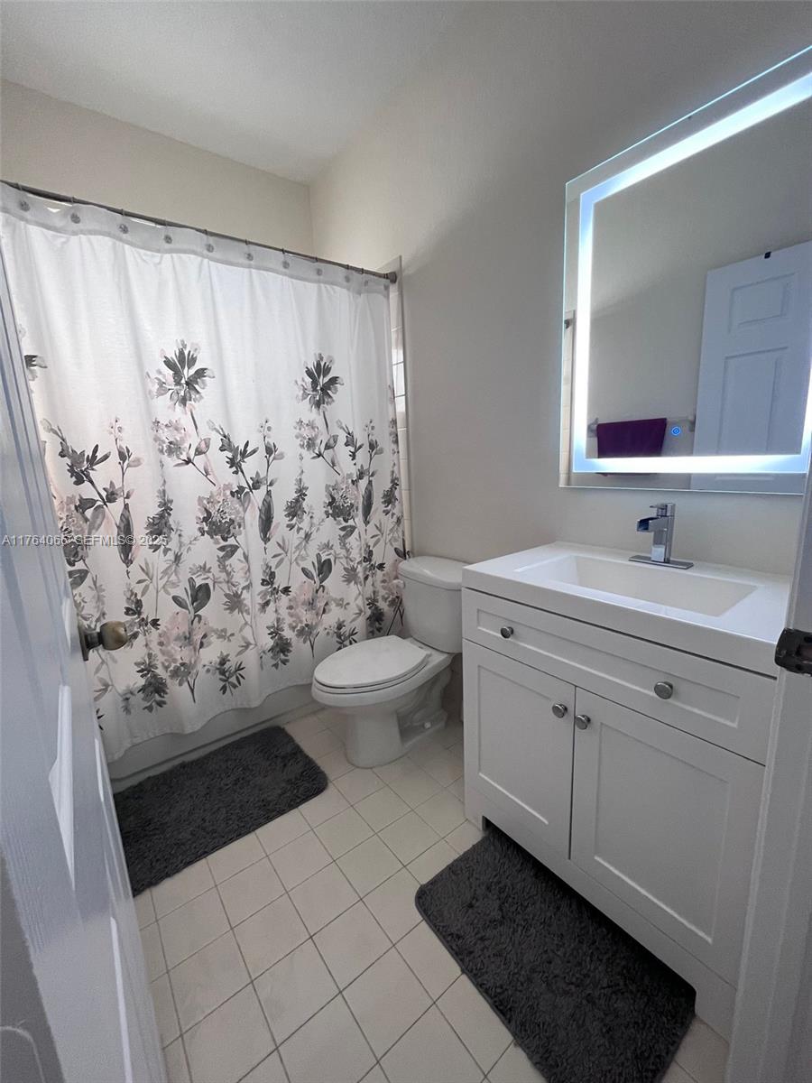 22937 Southwest 9th Avenue, Unit 1 Miami, FL 33170 - Photo 17 of 19 a bathroom with a sink toilet and mirror