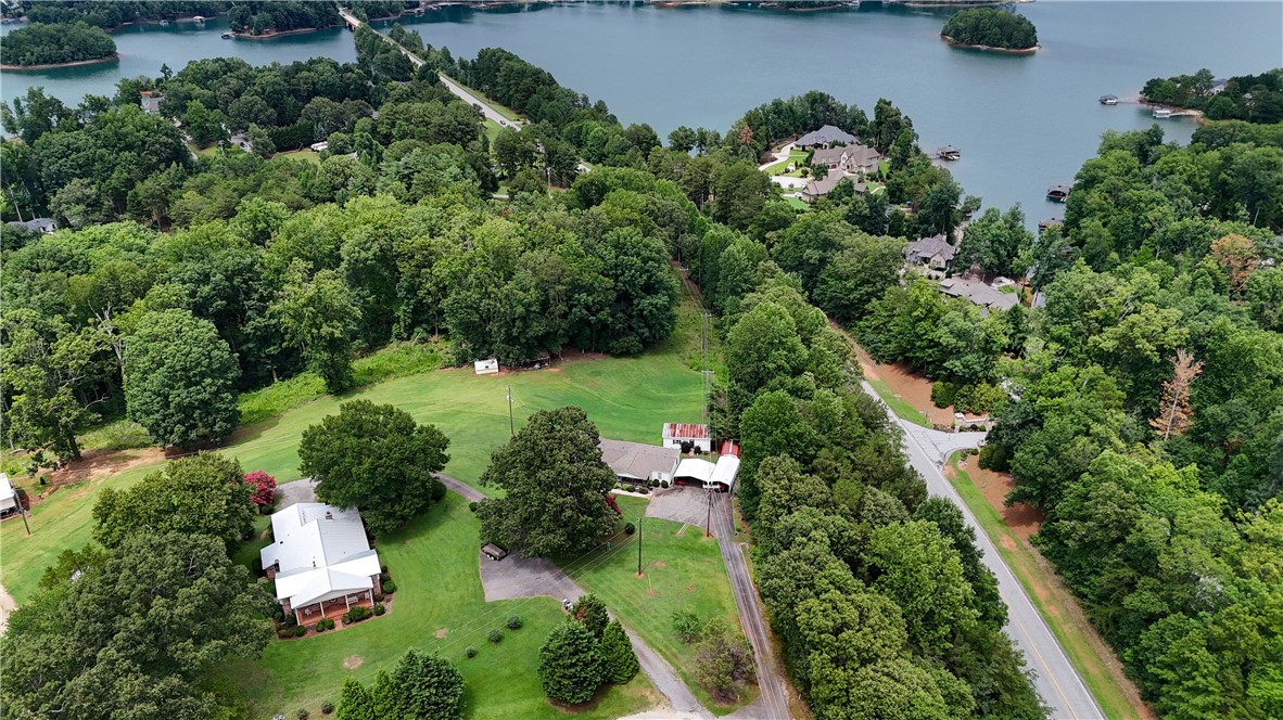 942 Chambers Hill Road Seneca, SC 29672 - Photo 2 of 38 Overlooking serene lake views, this sprawling property offers ample green space and a secluded residential setting.