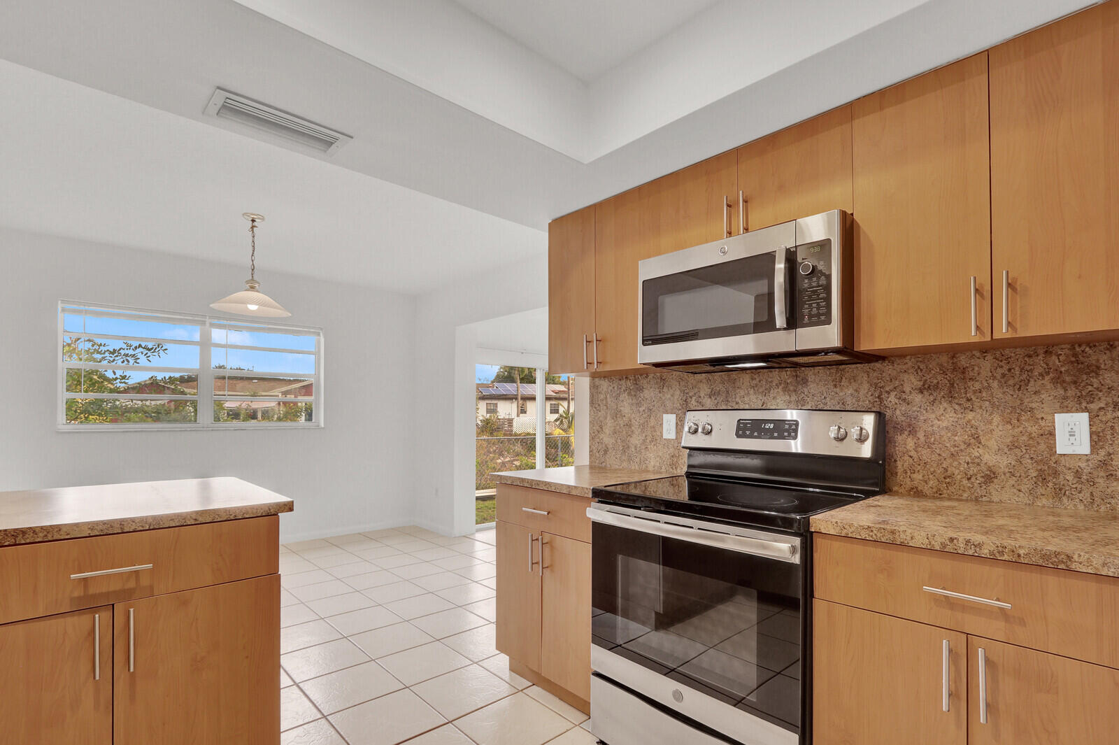 22600 Southwest 65th Way Boca Raton, FL 33428 - Photo 29 of 46 a kitchen with a stove and a microwave