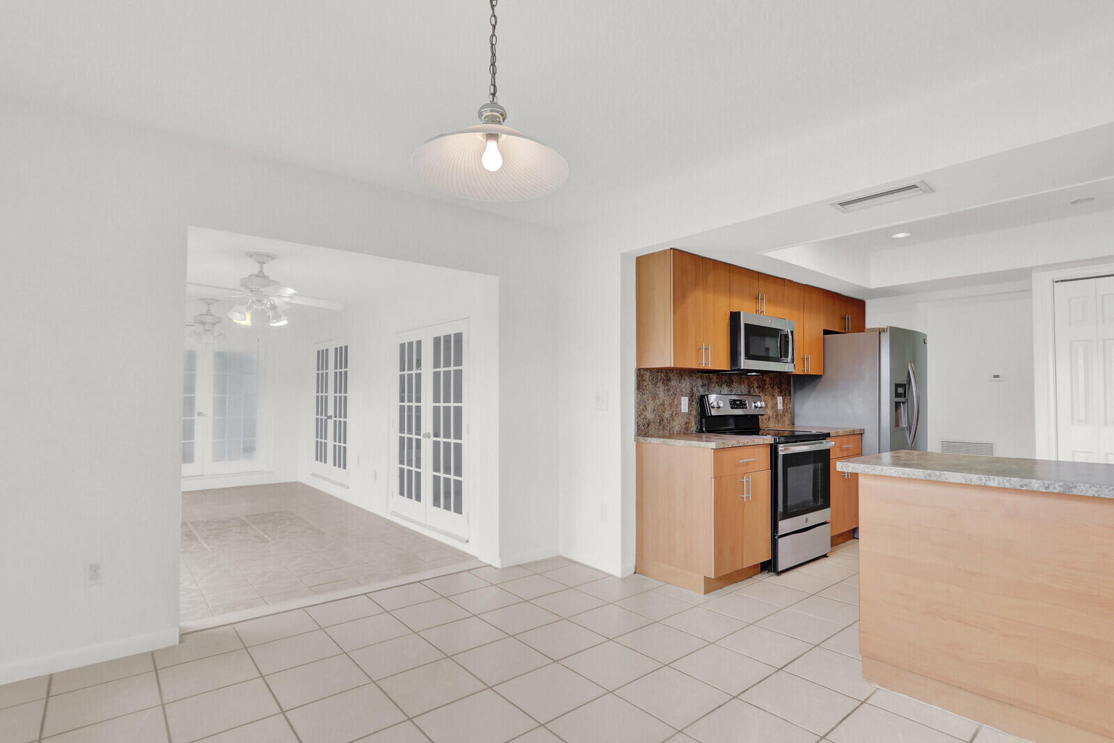 22600 Southwest 65th Way Boca Raton, FL 33428 - Photo 31 of 46 a view of a kitchen with microwave and cabinets