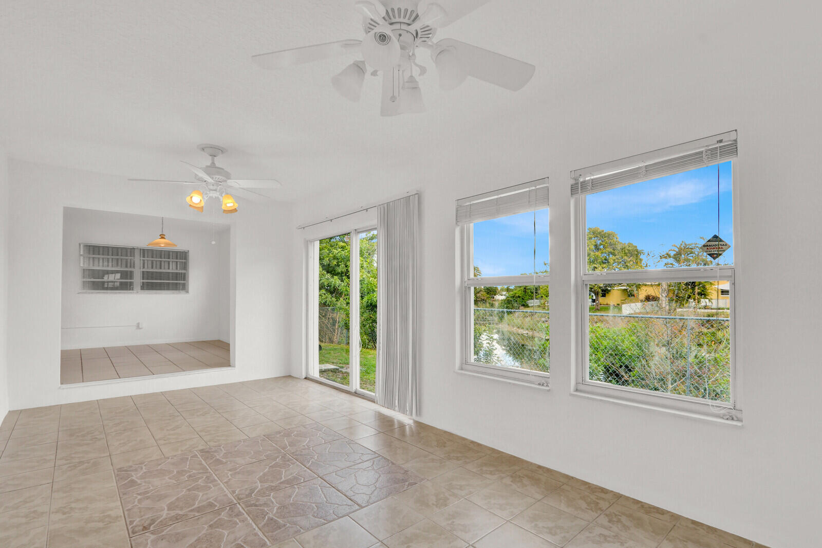 22600 Southwest 65th Way Boca Raton, FL 33428 - Photo 34 of 46 a view of livingroom with window ceiling fan and front door