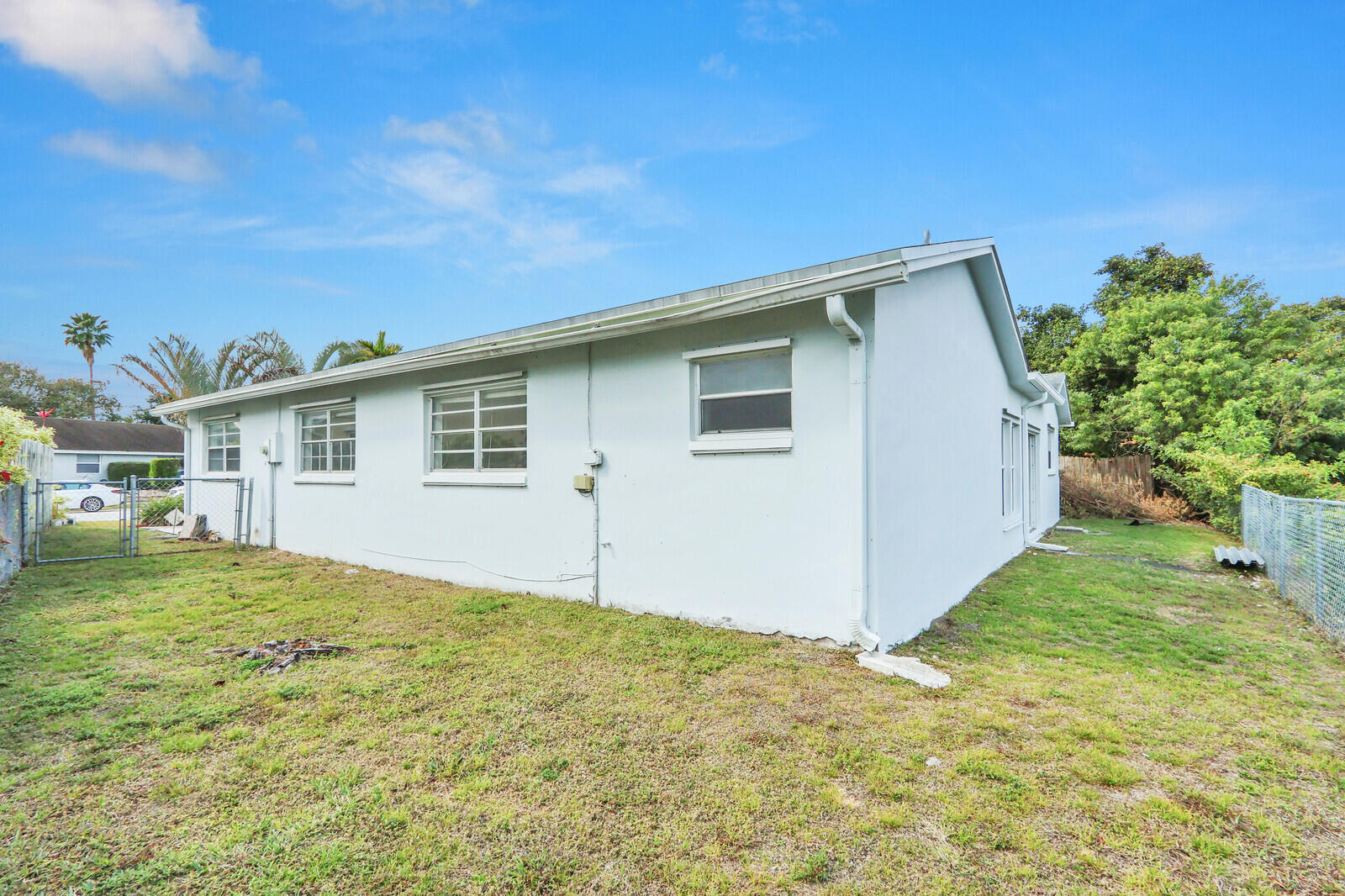 22600 Southwest 65th Way Boca Raton, FL 33428 - Photo 38 of 46 a front view of house with yard and trees in the background