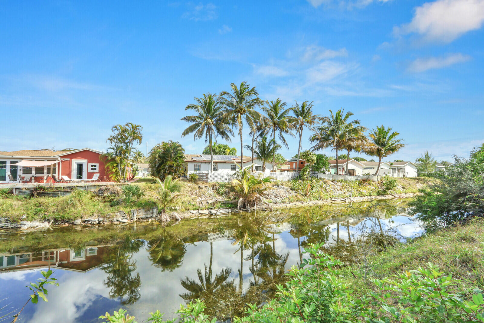 22600 Southwest 65th Way Boca Raton, FL 33428 - Photo 42 of 46 a view of a lake with a house in the background