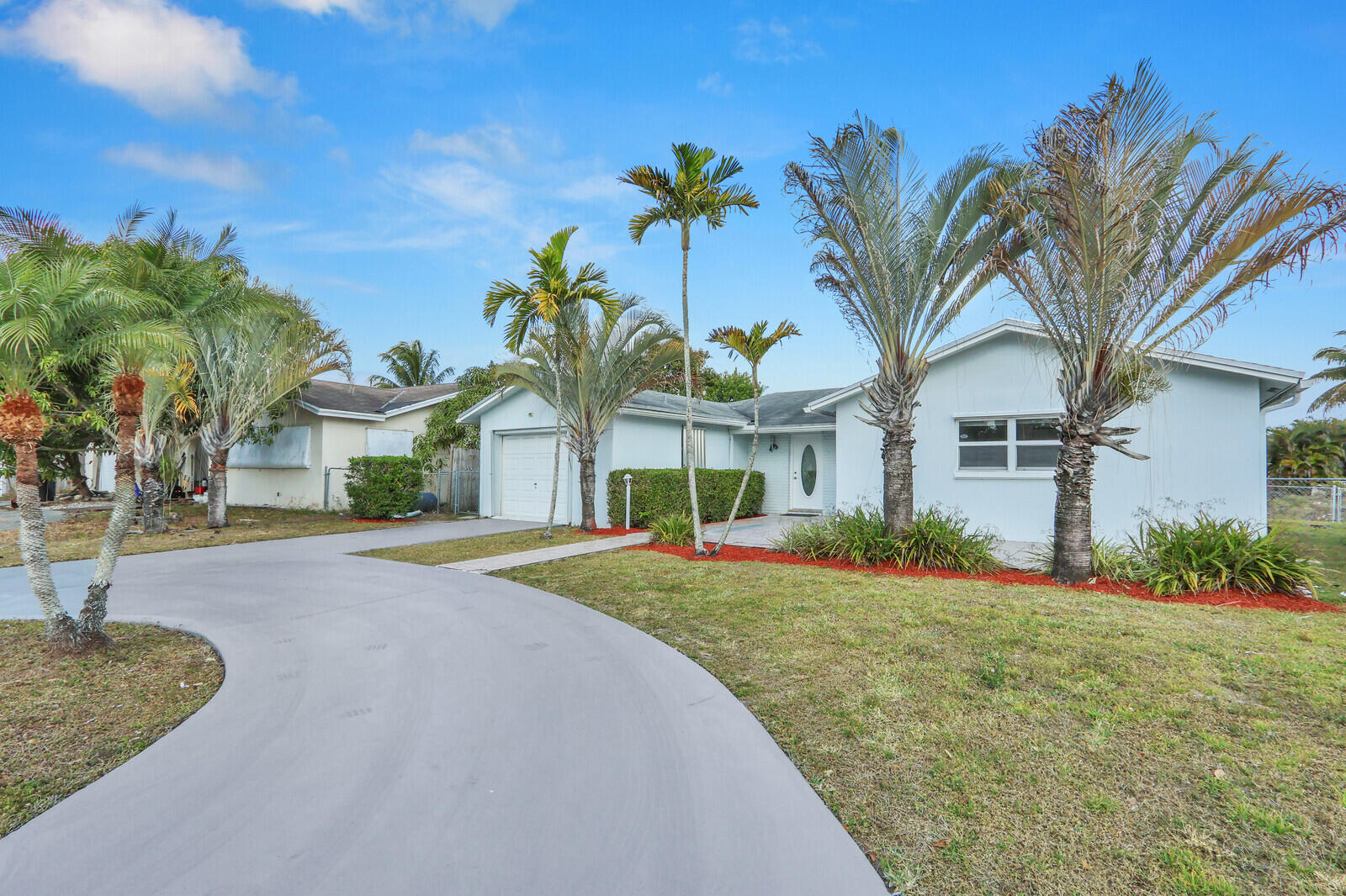 22600 Southwest 65th Way Boca Raton, FL 33428 - Photo 45 of 46 a front view of a house with a garden and palm trees