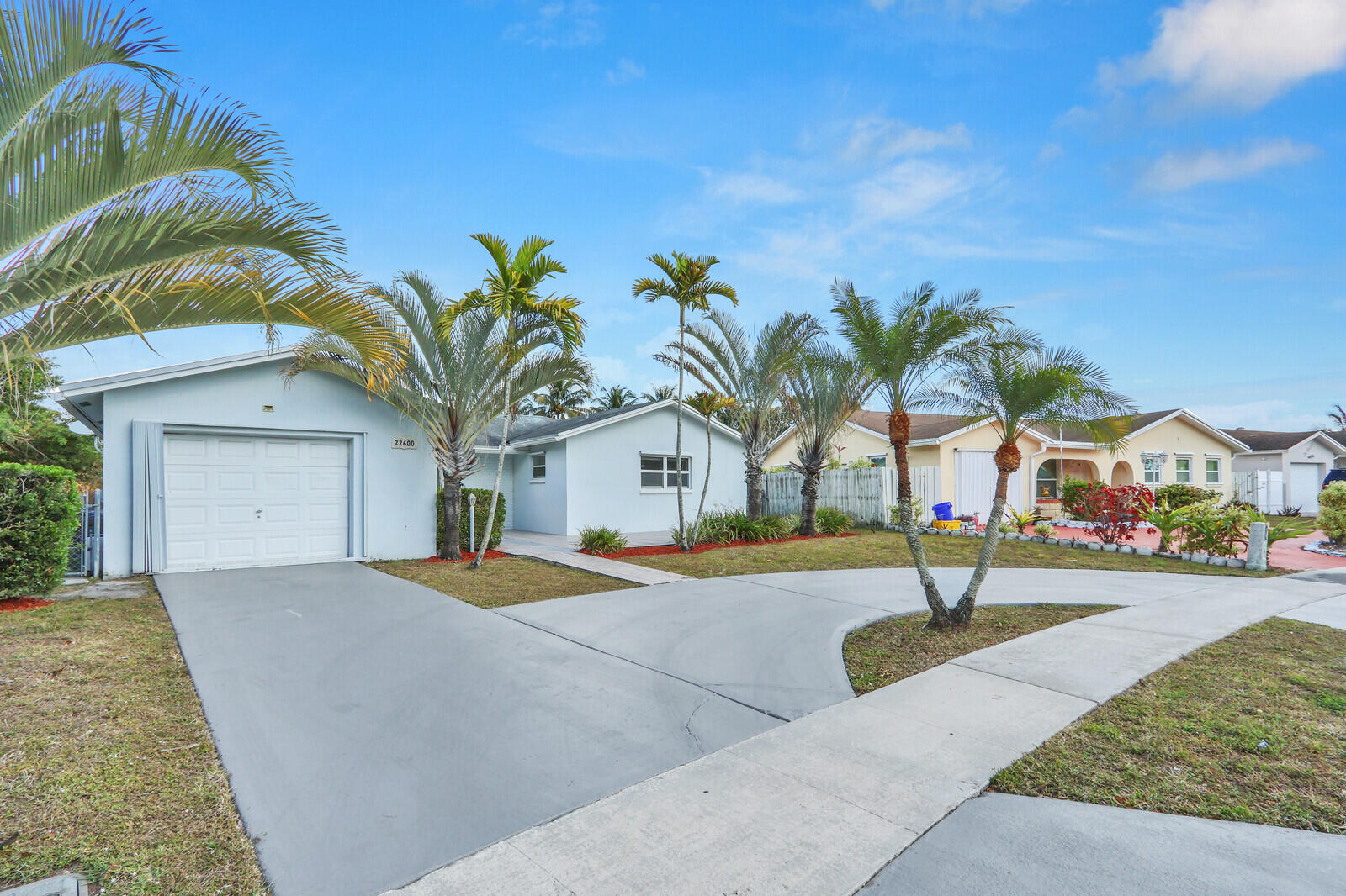 22600 Southwest 65th Way Boca Raton, FL 33428 - Photo 46 of 46 a front view of a house with a yard and garage