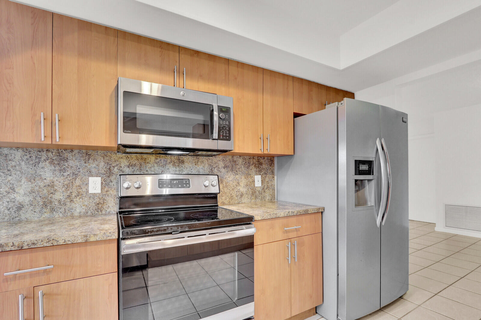 22600 Southwest 65th Way Boca Raton, FL 33428 - Photo 6 of 46 a kitchen with stainless steel appliances granite countertop a refrigerator stove and microwave