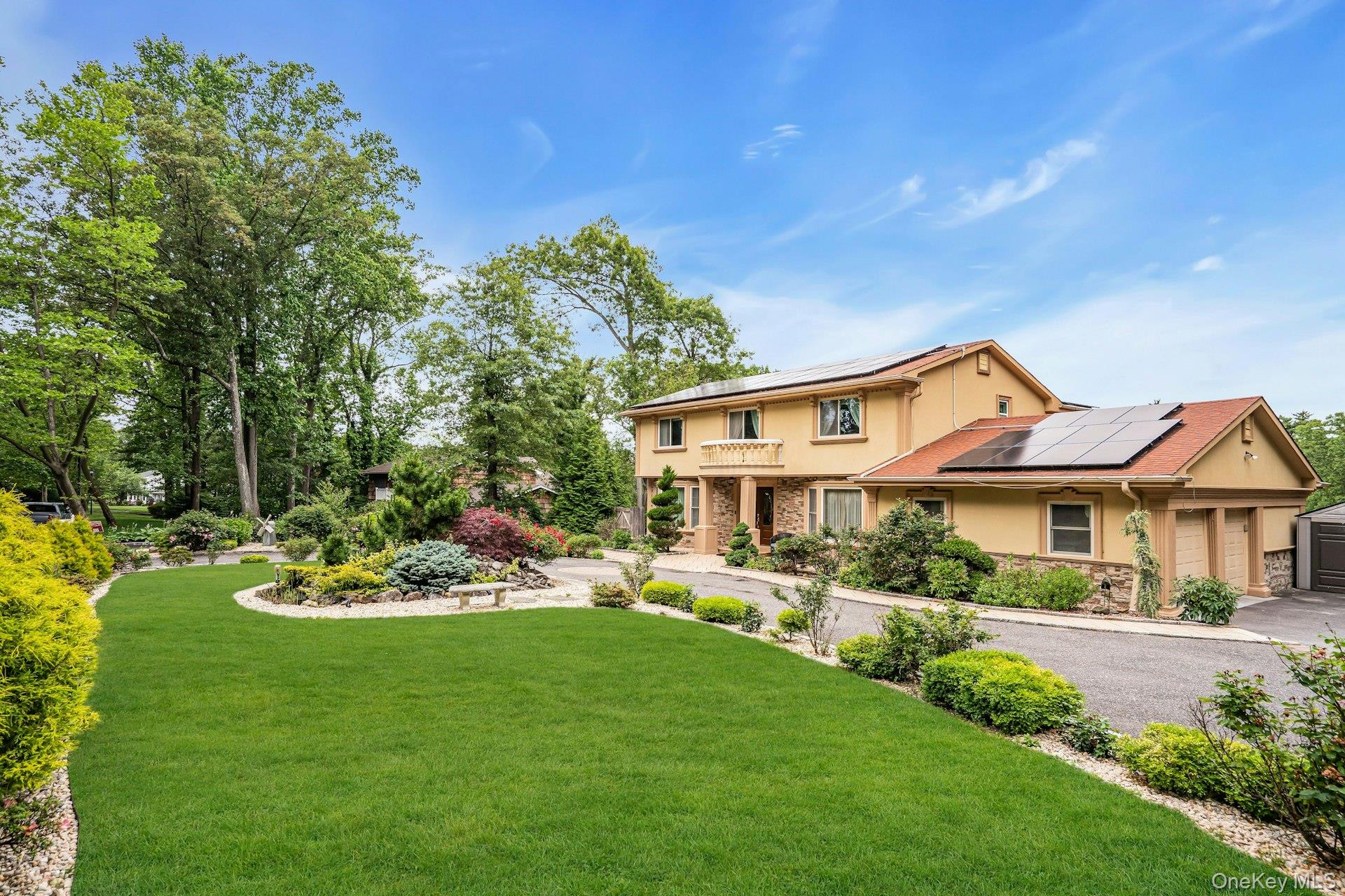 41 Hearthstone Drive Dix Hills, NY 11746 - Photo 1 of 50 a front view of a house with a garden and sitting area
