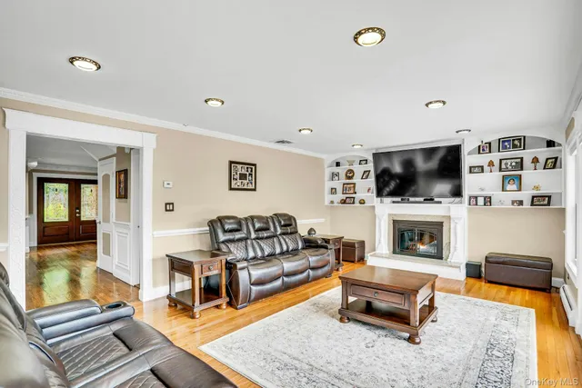 a living room with furniture flat screen tv and a fireplace