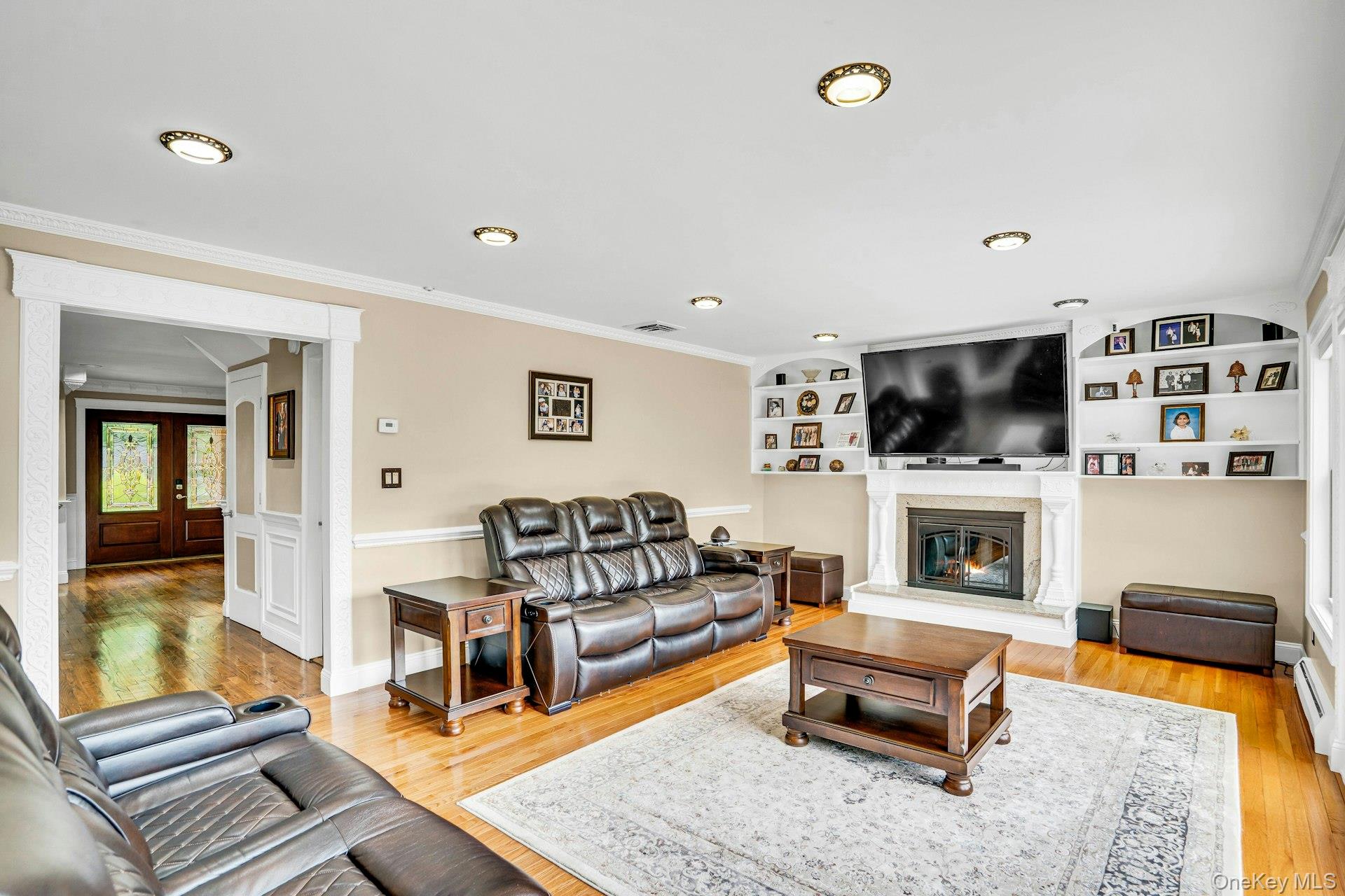 41 Hearthstone Drive Dix Hills, NY 11746 - Photo 15 of 50 a living room with furniture flat screen tv and a fireplace