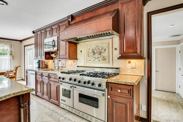 a kitchen with stainless steel appliances a stove a sink and a microwave