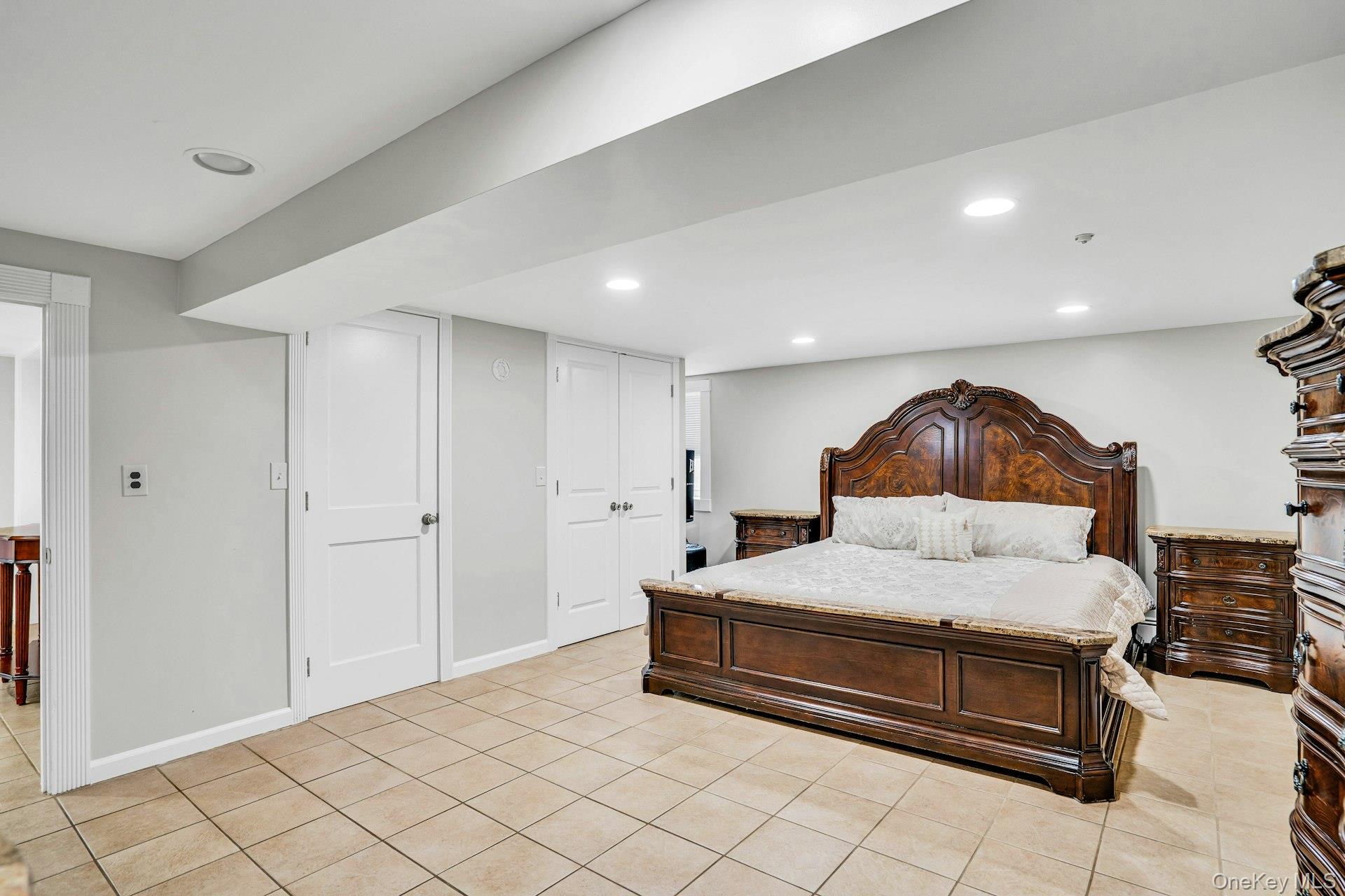 41 Hearthstone Drive Dix Hills, NY 11746 - Photo 35 of 50 a spacious bedroom with a bed and a lamp on dresser