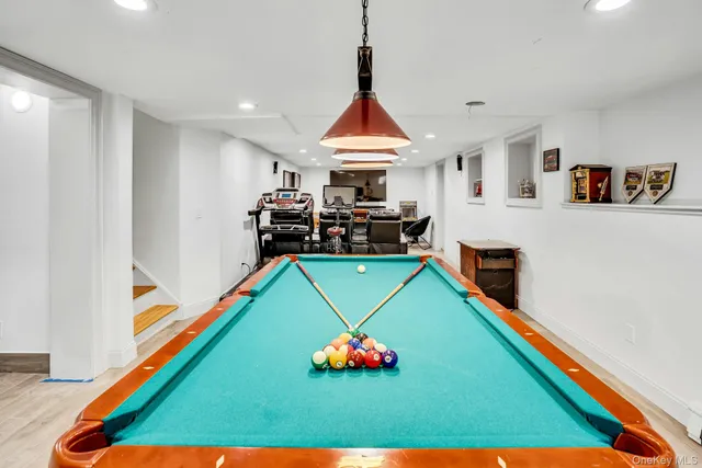 a room with pool table and windows