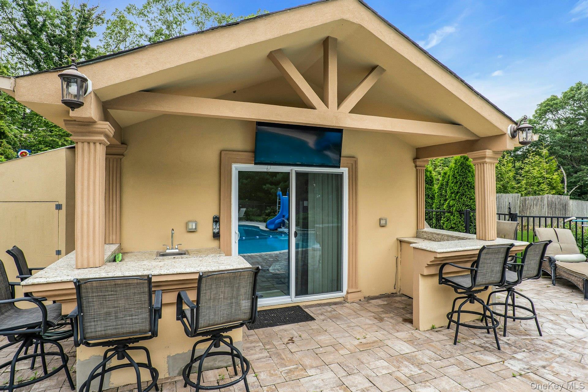 41 Hearthstone Drive Dix Hills, NY 11746 - Photo 48 of 50 a patio with table and chairs and potted plants