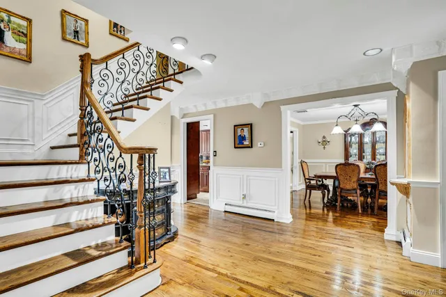 a view of entryway dining room and hall with wooden floor