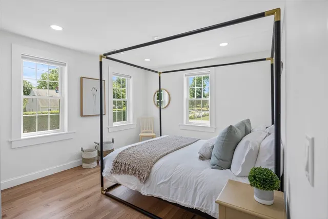 a bedroom with a large bed and a window