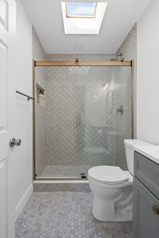 a bathroom with a toilet and a shower