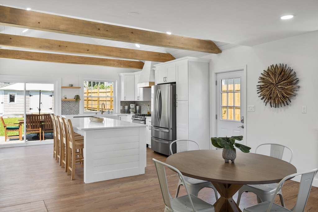 6 Stenbeck Place Scituate, MA 02066 - Photo 2 of 24 a kitchen with stainless steel appliances granite countertop a stove a refrigerator a table and chairs