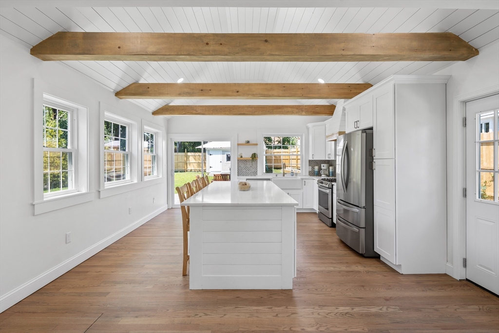6 Stenbeck Place Scituate, MA 02066 - Photo 4 of 24 a kitchen with stainless steel appliances granite countertop a refrigerator a stove and a wooden floors