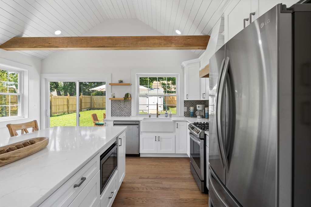 6 Stenbeck Place Scituate, MA 02066 - Photo 8 of 24 a kitchen with a sink a refrigerator and a stove top oven
