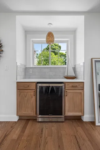 a kitchen with granite countertop a stove and a wooden floors