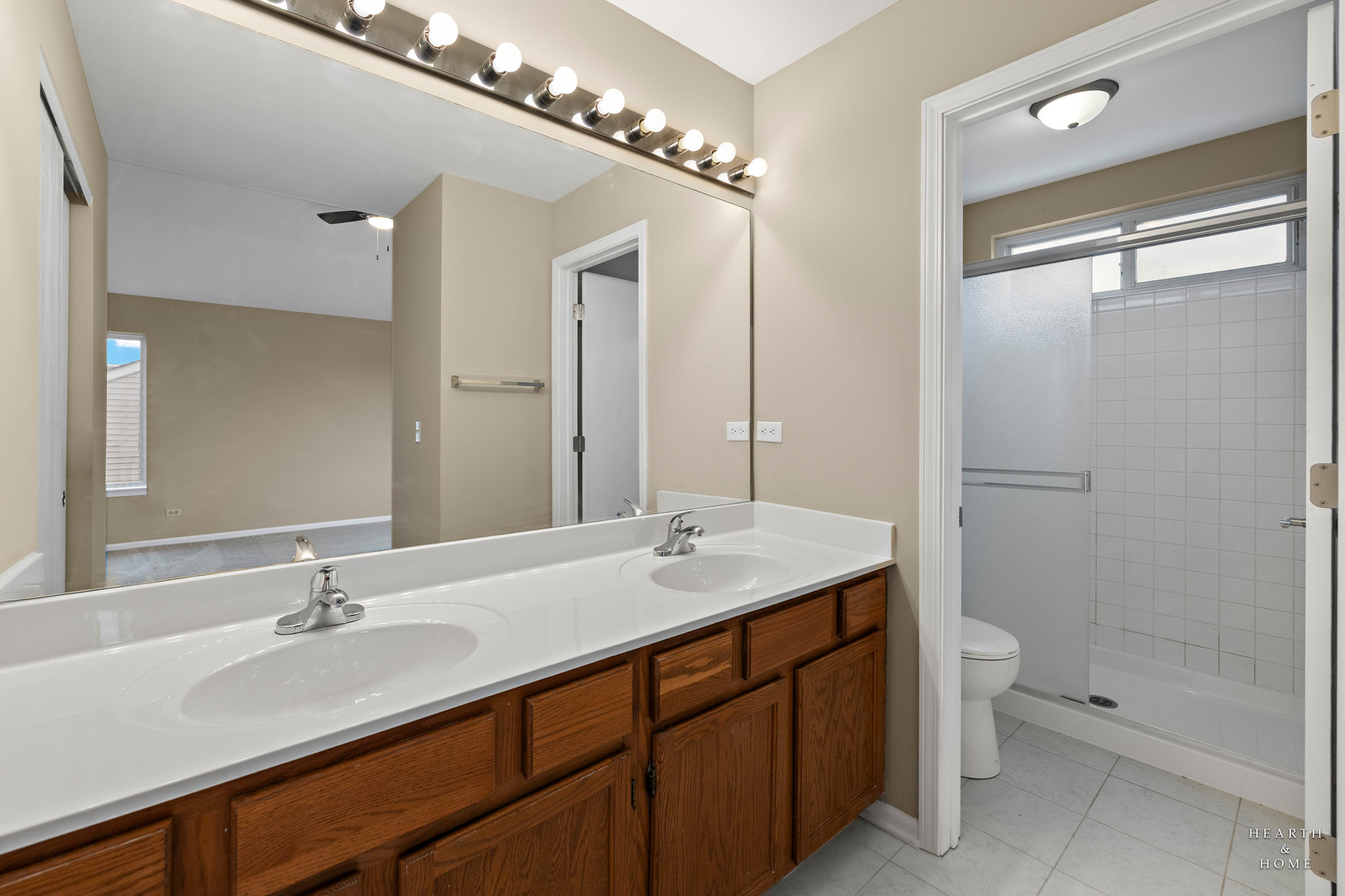 305 Harvest Gate Road Lake In The Hills, IL 60156 - Photo 18 of 36 a bathroom with a double vanity sink toilet and shower