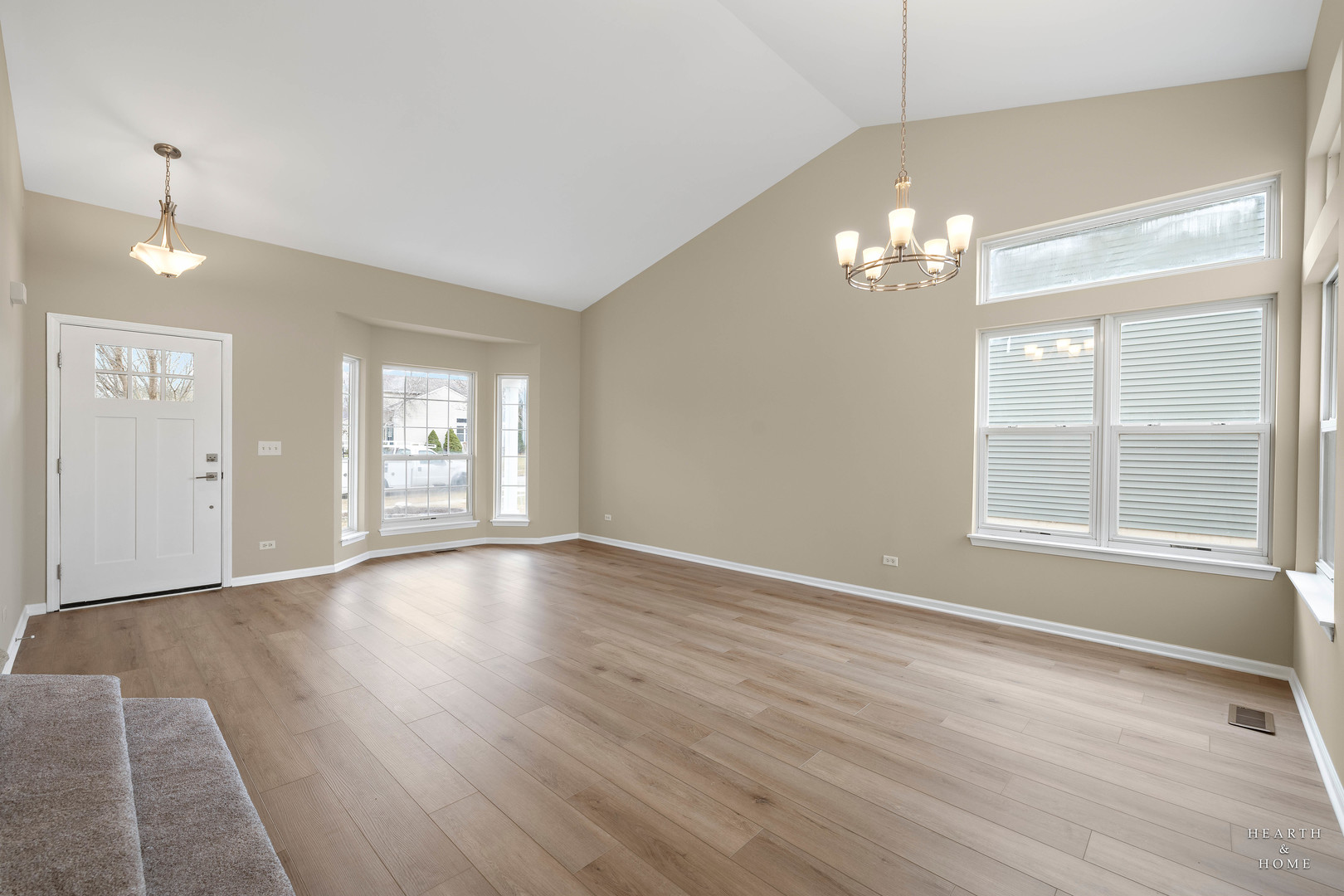 305 Harvest Gate Road Lake In The Hills, IL 60156 - Photo 2 of 36 a view of an empty room with a window and wooden floor