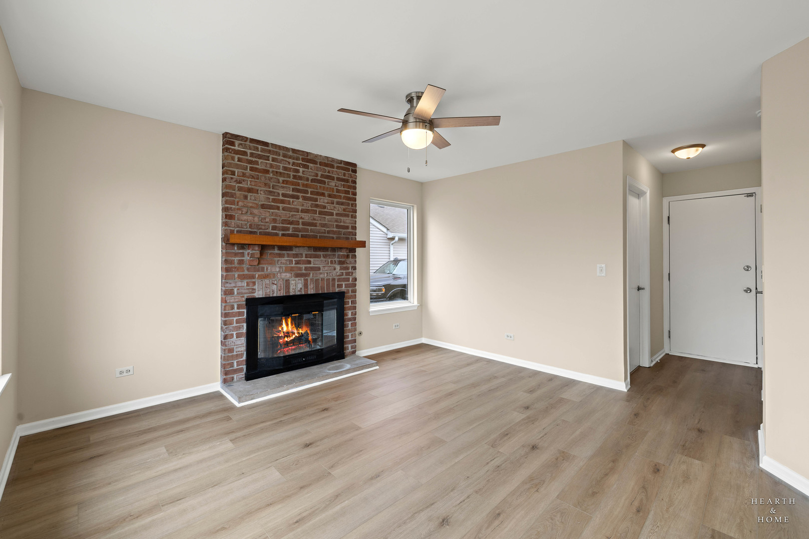 305 Harvest Gate Road Lake In The Hills, IL 60156 - Photo 23 of 36 a view of an empty room with wooden floor fireplace and a window