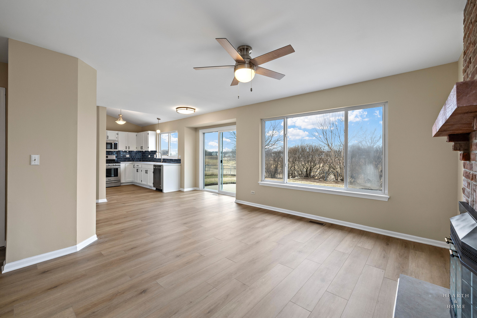 305 Harvest Gate Road Lake In The Hills, IL 60156 - Photo 3 of 36 a view of an empty room with a window and wooden floor