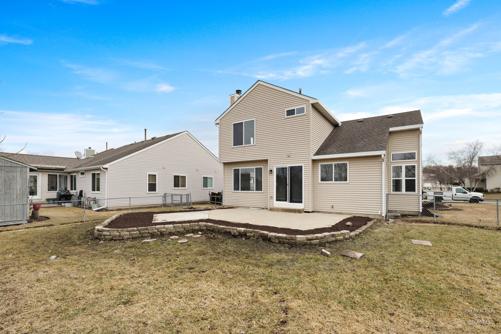 305 Harvest Gate Road Lake In The Hills, IL 60156 - Photo 31 of 36 a big white house with a large pool and lawn chairs under an umbrella