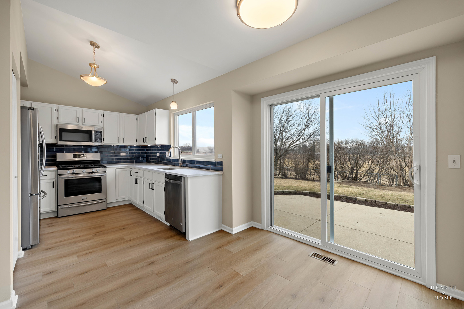 305 Harvest Gate Road Lake In The Hills, IL 60156 - Photo 4 of 36 a kitchen with granite countertop a stove top oven sink and cabinets