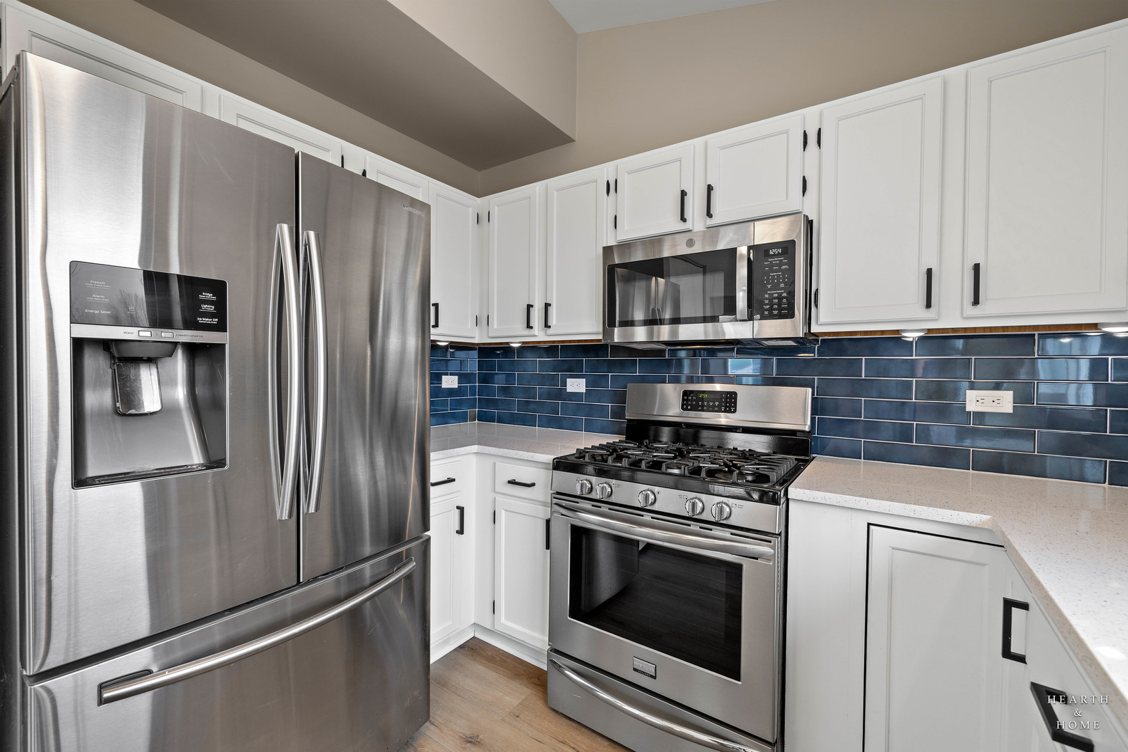 305 Harvest Gate Road Lake In The Hills, IL 60156 - Photo 6 of 36 a kitchen with stainless steel appliances a stove a microwave and a refrigerator