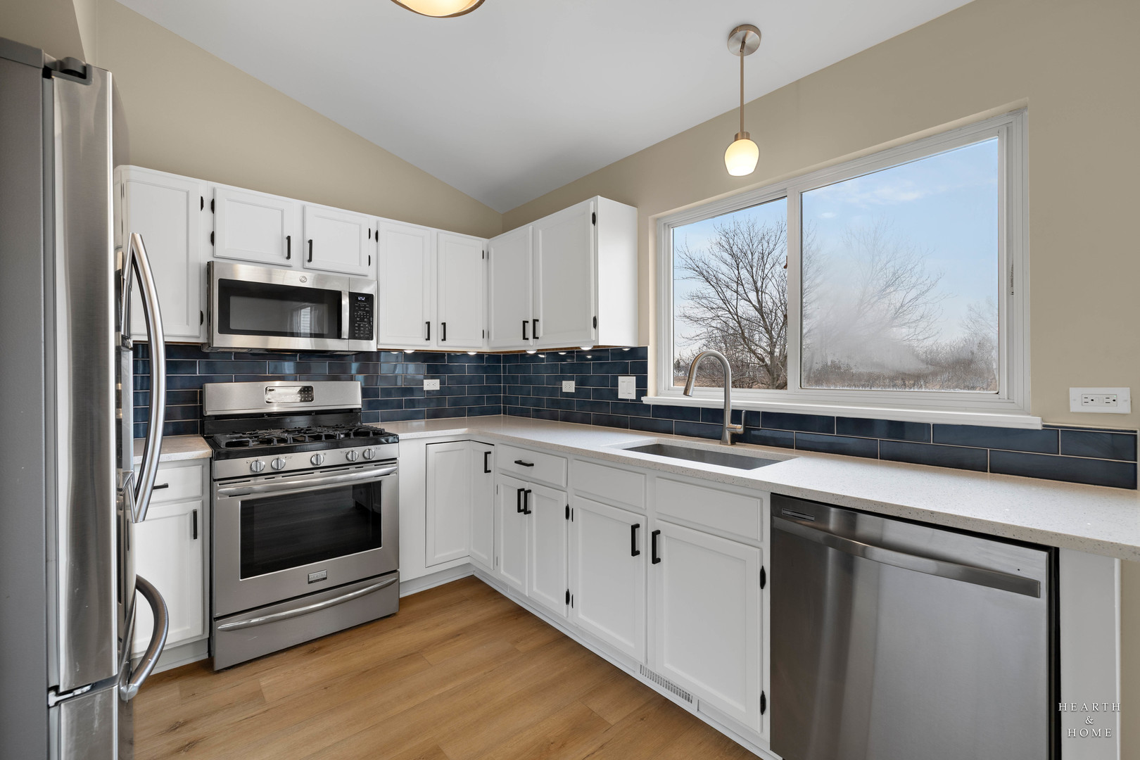 305 Harvest Gate Road Lake In The Hills, IL 60156 - Photo 7 of 36 a kitchen with stainless steel appliances a stove a sink and a microwave