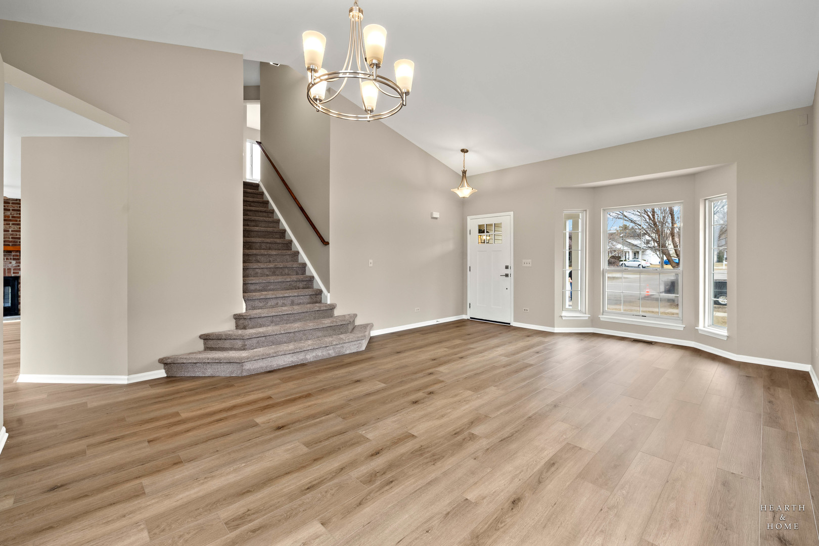 305 Harvest Gate Road Lake In The Hills, IL 60156 - Photo 9 of 36 a view of an empty room with wooden floor and stair
