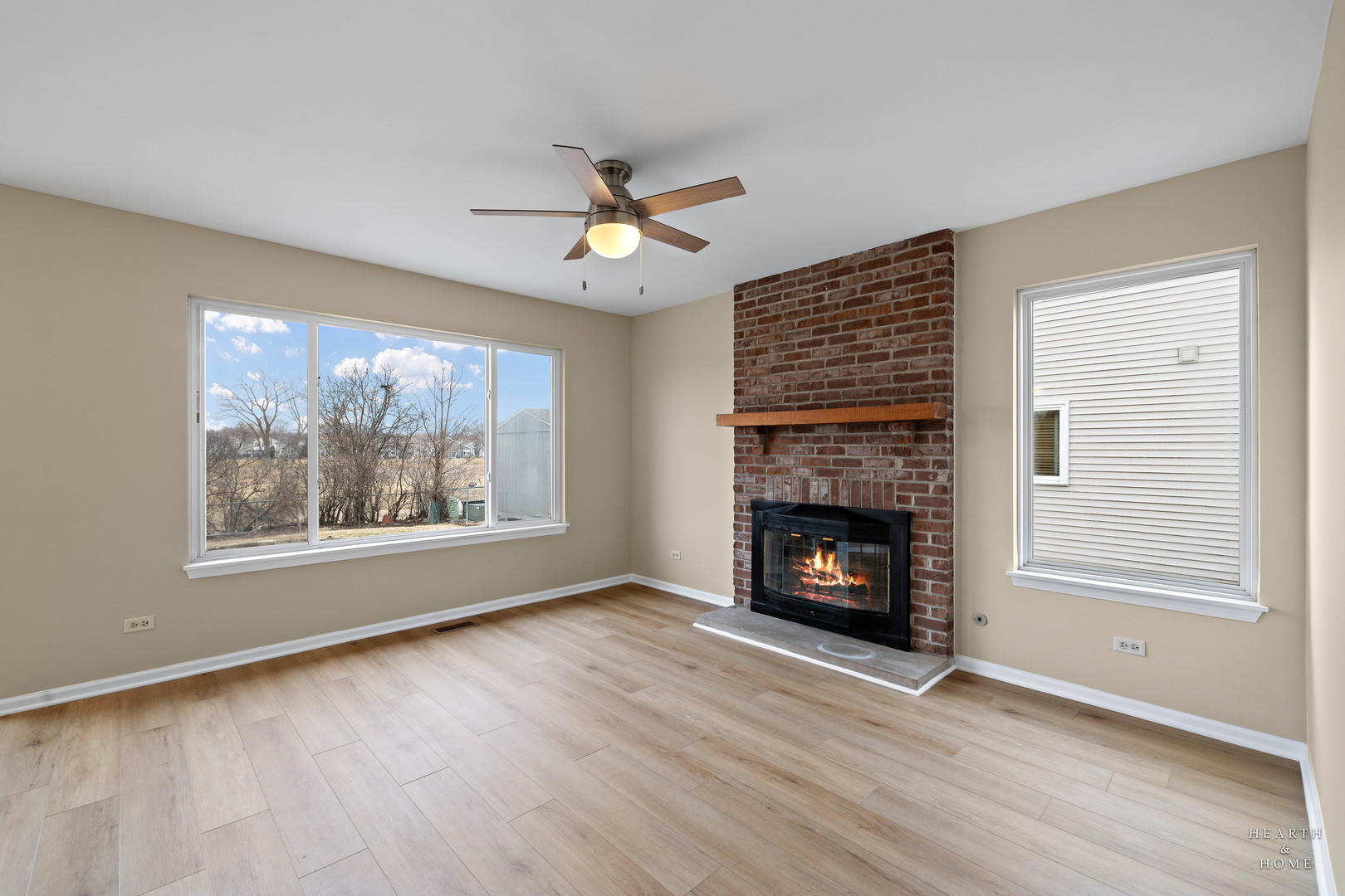 305 Harvest Gate Road Lake In The Hills, IL 60156 - Photo 10 of 36 wooden floor fireplace and windows in an empty room