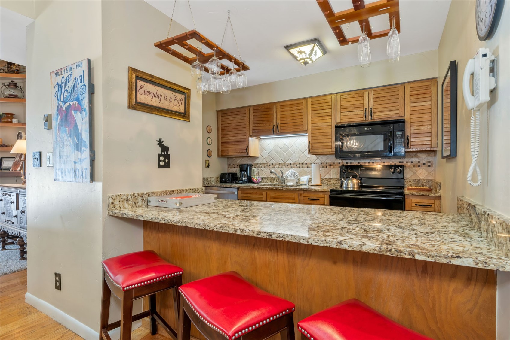 2025 Walton Creek Road, Unit 401 Steamboat Springs, CO 80487 - Photo 10 of 38 a kitchen with stainless steel appliances granite countertop a sink and a stove