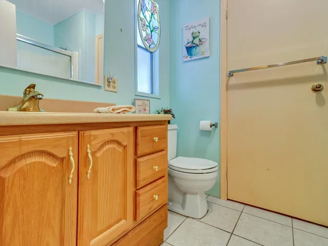 a bathroom with a sink a toilet and a shower curtain