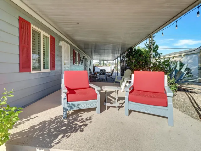 a view of a house with a backyard and porch