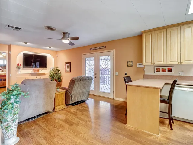 a living room with furniture a flat screen tv and next to a window