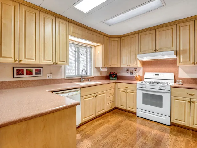 a kitchen with a stove a sink and a refrigerator