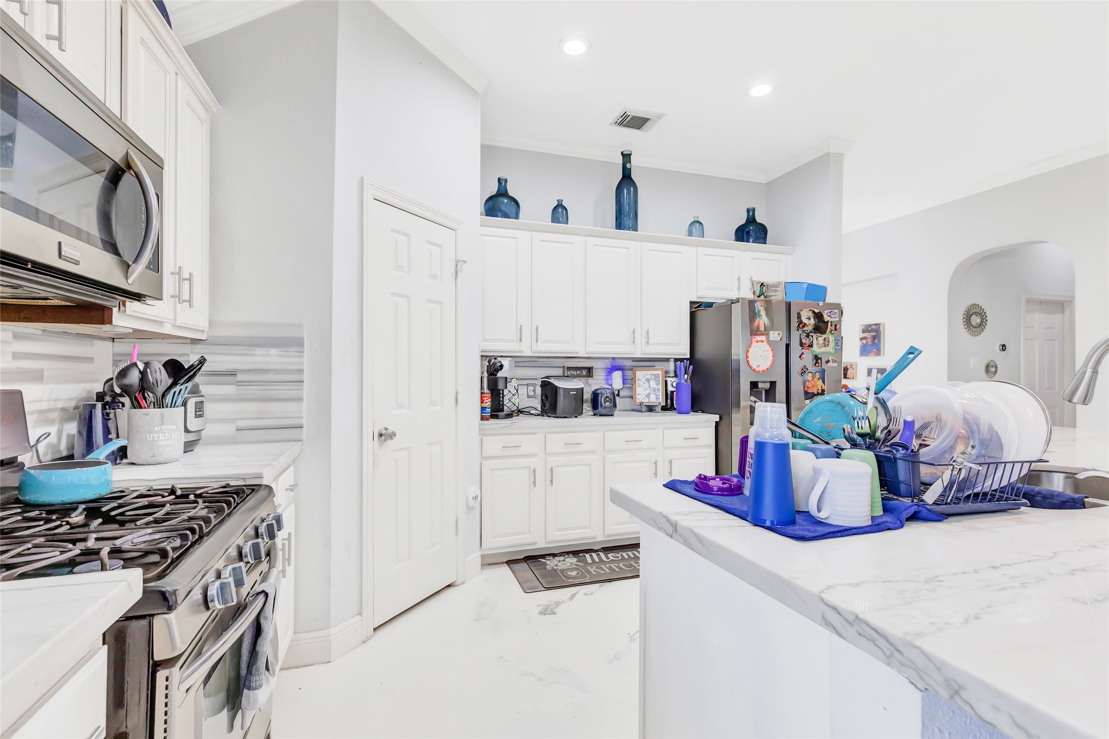 14415 Red Mulberry Lane Houston, TX 77044 - Photo 13 of 26 a kitchen with a refrigerator and white cabinets