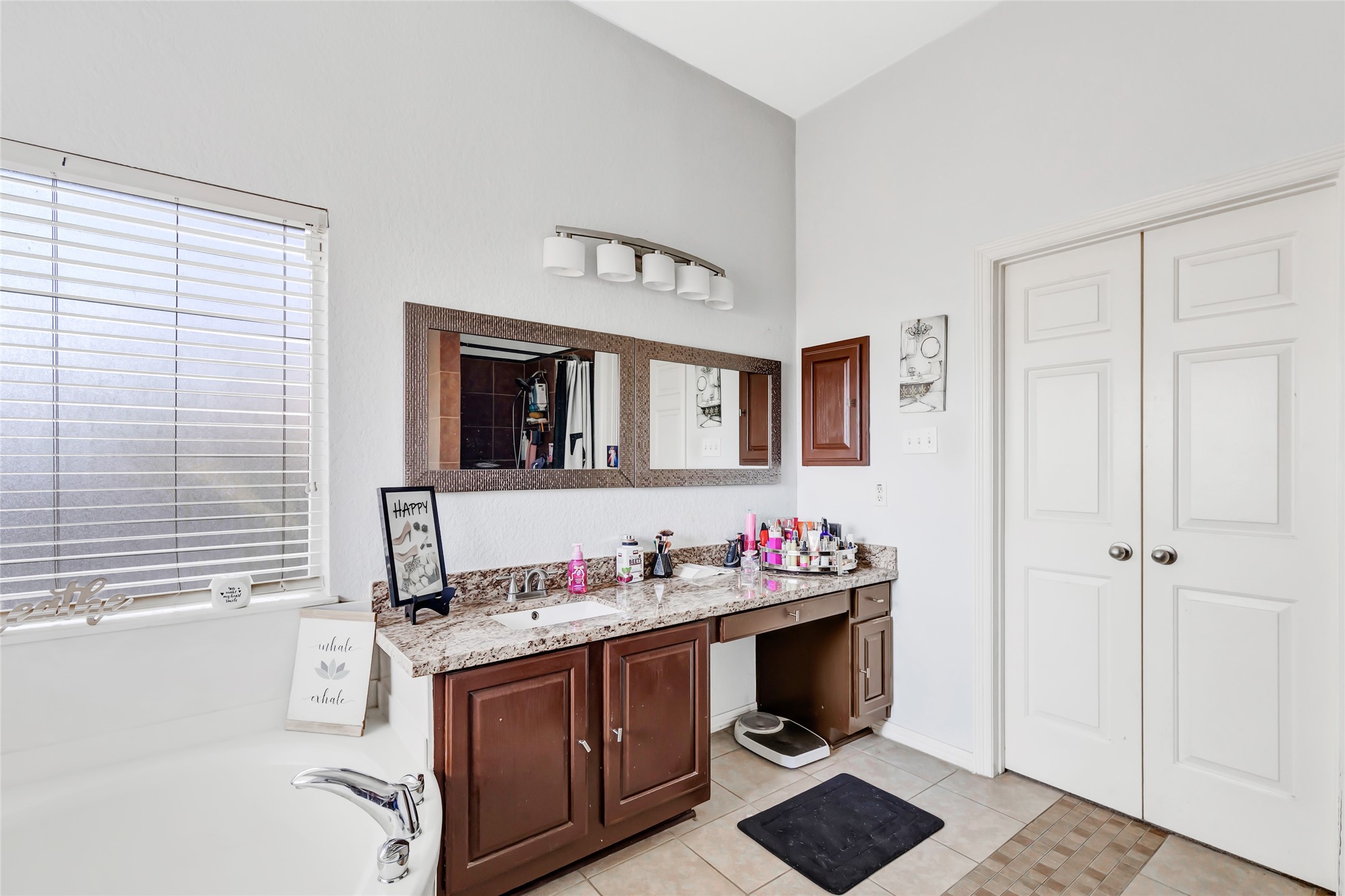 14415 Red Mulberry Lane Houston, TX 77044 - Photo 20 of 26 a bathroom with a granite countertop sink and a mirror